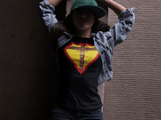 Faith, Royalty & Christian shirts for women — 'Queen' Edition T-Shirt in black featuring Christ crucifix and crown, worn with denim jacket and cap.